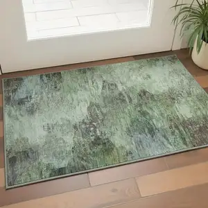 Photo of Green Brown And Ivory Abstract Washable Area Rug With UV Protection