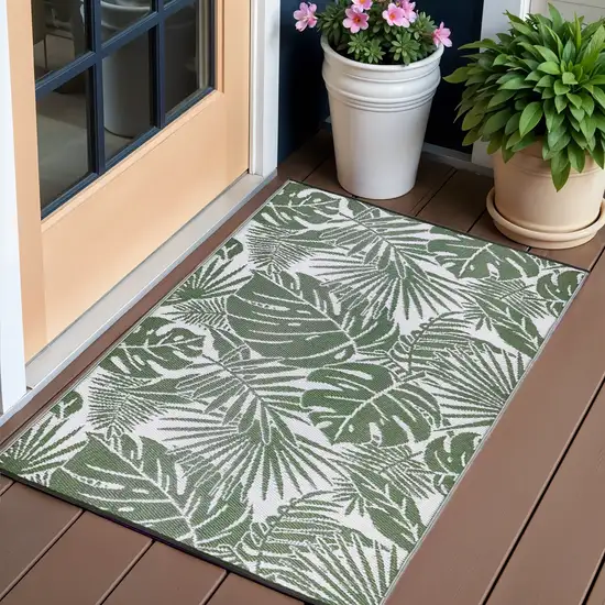 Green Floral Machine Braided Distressed Area Rug With UV Protection Photo 1