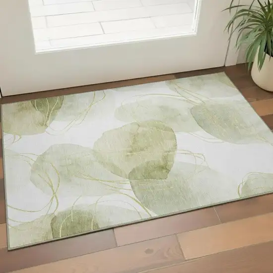 Green Gold And Ivory Abstract Washable Area Rug With UV Protection Photo 1
