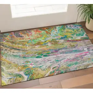 Photo of Green Gold And Teal Abstract Washable Area Rug With UV Protection