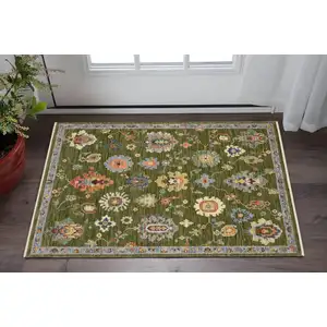 Photo of Green Gray And Light Blue Oriental Area Rug With Fringe