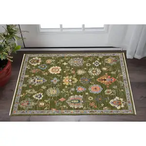 Photo of Green Ivory And Blue Oriental Area Rug With Fringe