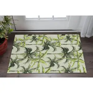 Photo of Green Ivory And Charcoal Geometric Washable Area Rug With UV Protection
