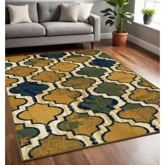 Green Brown And Ivory Quatrefoil Distressed Area Rug Photo 1