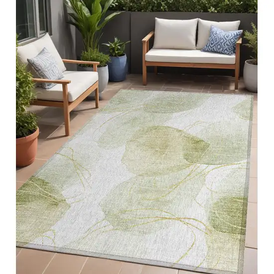 Green and Ivory Abstract Washable Non Skid Indoor Outdoor Area Rug Photo 1