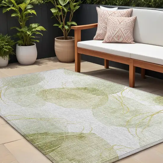 Green and Ivory Abstract Washable Non Skid Indoor Outdoor Area Rug Photo 1