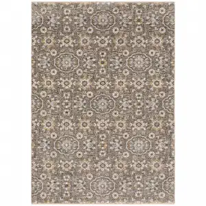 Photo of Grey And Tan Floral Power Loom Stain Resistant Area Rug With Fringe