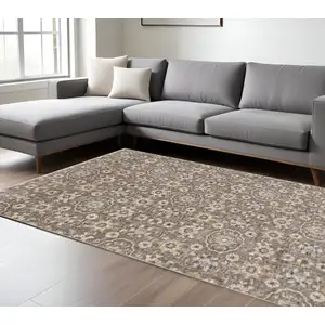 Photo of Grey And Tan Floral Power Loom Stain Resistant Area Rug With Fringe