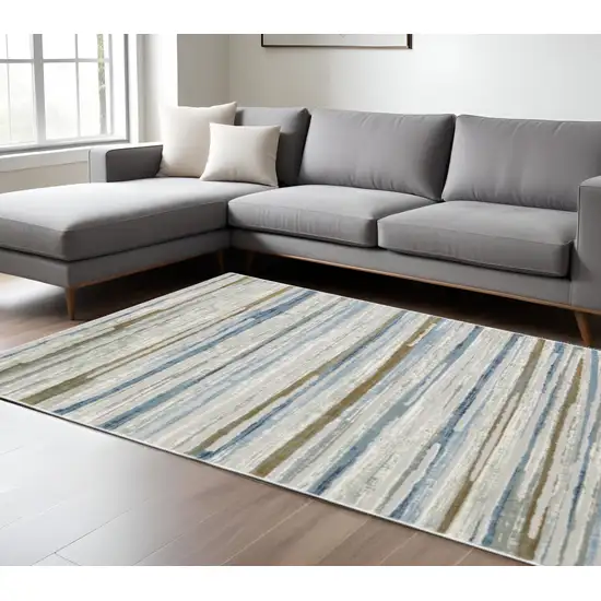 6' X 9' Grey Blue Ivory Brown Beige And Navy Abstract Power Loom Stain Resistant Area Rug Photo 1