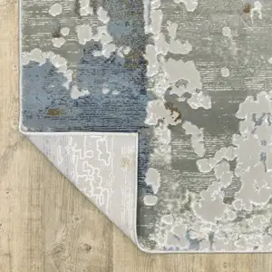 Photo of Grey Blue Navy Ivory And Brown Abstract Power Loom Stain Resistant Runner Rug