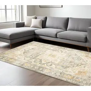 Photo of Grey Gold Orange And Ivory Oriental Power Loom Stain Resistant Area Rug