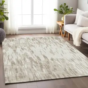 Photo of Ivory And Beige Abstract Washable Area Rug With UV Protection