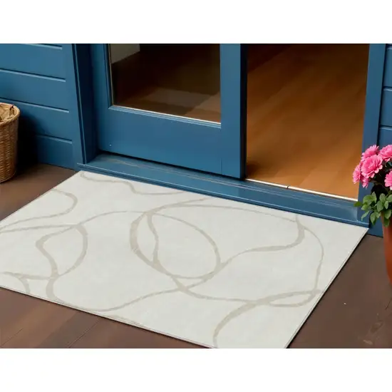 Ivory And Beige Abstract Washable Indoor Outdoor Area Rug Photo 1