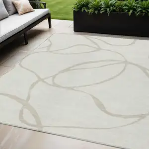 Photo of Ivory And Beige Abstract Washable Indoor Outdoor Area Rug
