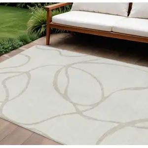 Photo of Ivory And Beige Abstract Washable Indoor Outdoor Area Rug