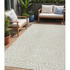 Photo of Ivory And Beige Abstract Washable Indoor Outdoor Area Rug