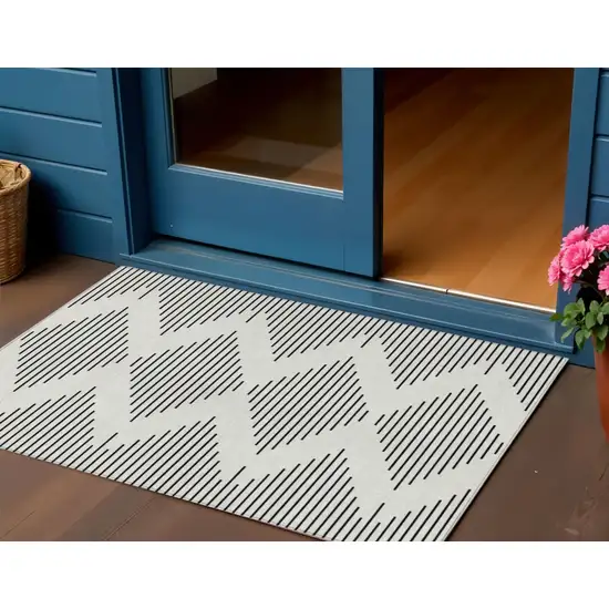 Ivory And Black Geometric Washable Indoor Outdoor Area Rug Photo 1