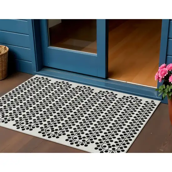 Ivory And Black Geometric Washable Indoor Outdoor Area Rug Photo 1