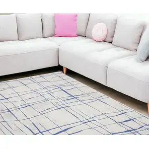 Photo of Ivory And Blue Abstract Distressed Area Rug