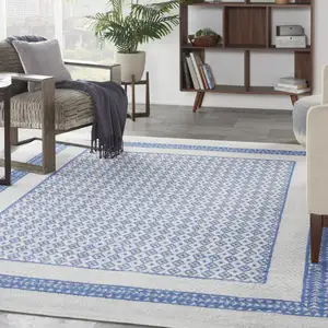 Photo of Ivory And Blue Geometric Distressed Area Rug