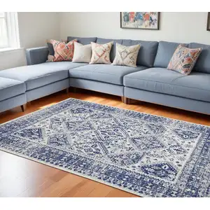 Photo of Ivory And Blue Geometric Distressed Area Rug