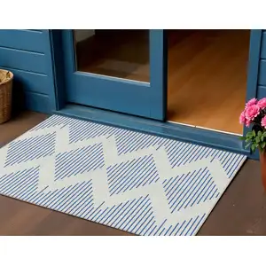 Photo of Ivory And Blue Geometric Washable Indoor Outdoor Area Rug