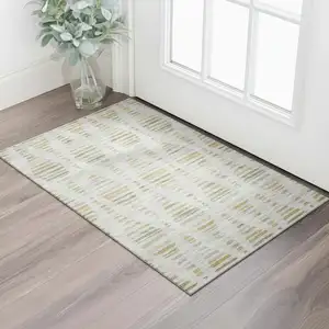 Photo of Ivory And Gold Striped Washable Area Rug With UV Protection