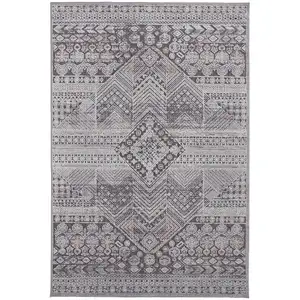 Photo of Ivory And Gray Geometric Power Loom Distressed Stain Resistant Area Rug