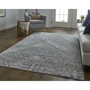 Photo of Ivory And Gray Geometric Power Loom Distressed Stain Resistant Area Rug