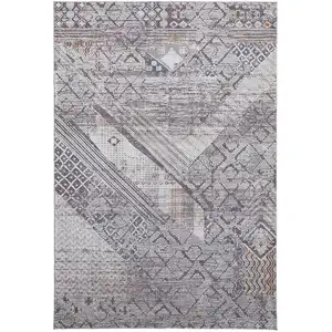 Photo of Ivory And Gray Geometric Power Loom Distressed Stain Resistant Area Rug
