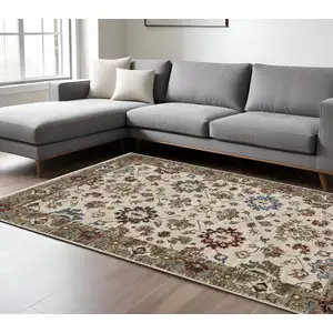 Photo of Ivory And Green Oriental Area Rug With Fringe