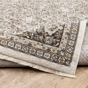 Photo of Ivory And Grey Oriental Power Loom Stain Resistant Area Rug With Fringe