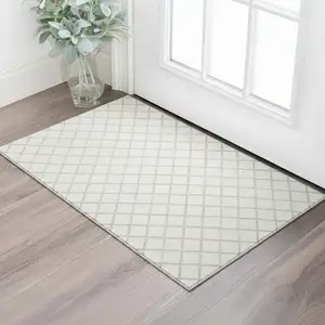 Photo of Ivory And Taupe Geometric Washable Area Rug With UV Protection