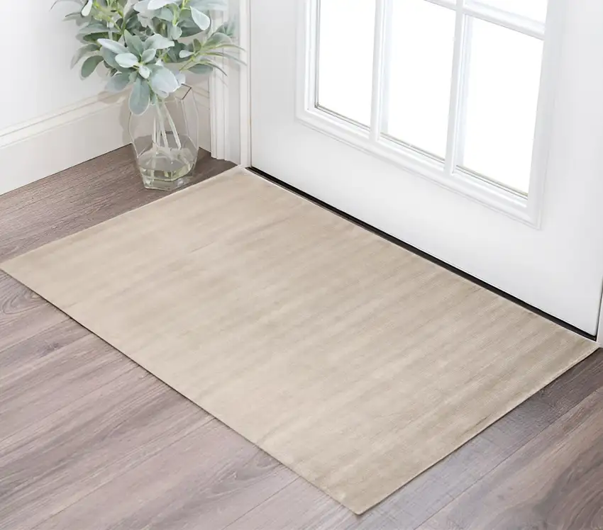 Ivory And Taupe Hand Woven Distressed Area Rug Photo 1