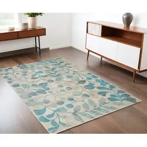 Photo of Ivory And Turquoise Botanical Leaves Area Rug