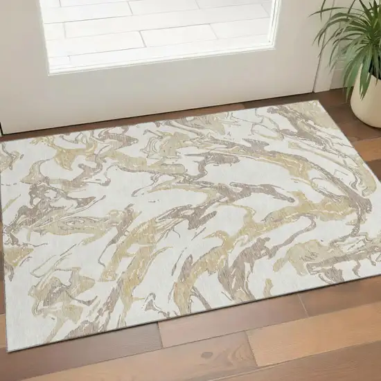 Ivory Beige And Gold Abstract Washable Area Rug With UV Protection Photo 1
