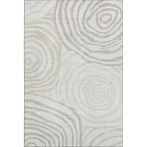 Photo of Ivory Beige And Khaki Abstract Washable Area Rug With UV Protection