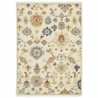 Photo of Ivory Beige Gold Grey Blue Pink Red Rust And Green Oriental Power Loom Stain Resistant Area Rug With Fringe