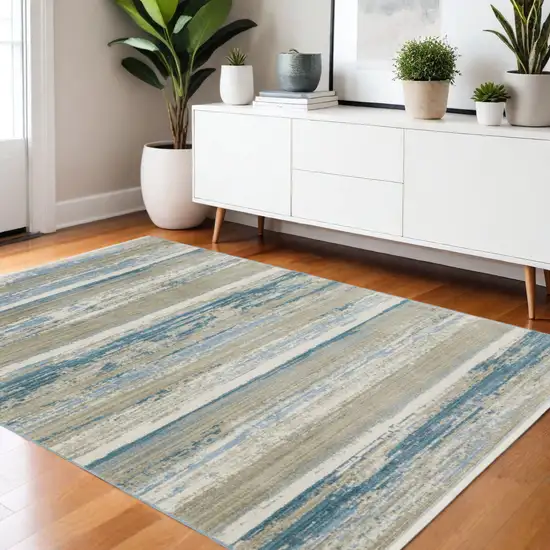 Ivory Beige Grey Blue And Tan Abstract Power Loom Stain Resistant Area Rug With Fringe Photo 1