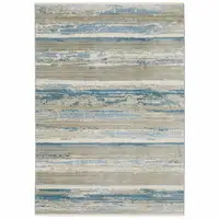 Photo of Ivory Beige Grey Blue And Tan Abstract Power Loom Stain Resistant Area Rug With Fringe
