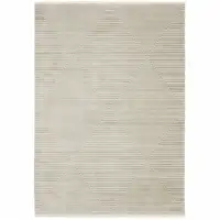 Photo of Ivory Beige Taupe And Tan Geometric Power Loom Stain Resistant Area Rug With Fringe