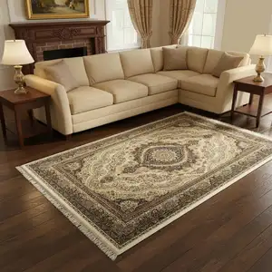 Photo of Ivory Black And Tan Medallion Area Rug With Fringe