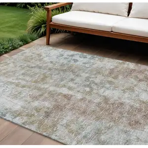 Photo of Ivory Blue And Gold Abstract Washable Indoor Outdoor Area Rug