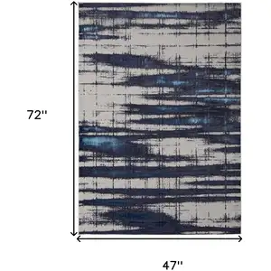 Photo of Ivory Blue And Gray Abstract Power Loom Distressed Area Rug