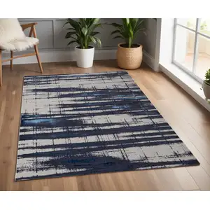 Photo of Ivory Blue And Gray Abstract Power Loom Distressed Area Rug