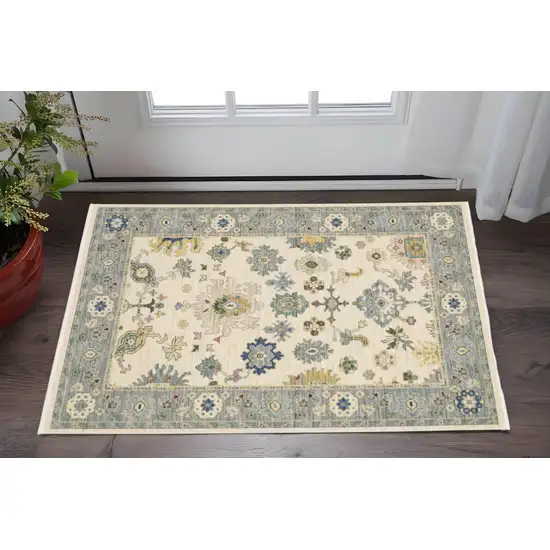 Ivory Blue Grey Teal Gold Green And Rust Oriental Power Loom Stain Resistant Area Rug With Fringe Photo 1
