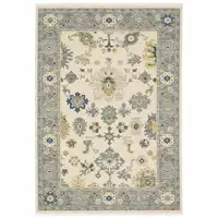 Photo of Ivory Blue Grey Teal Gold Green And Rust Oriental Power Loom Stain Resistant Area Rug With Fringe