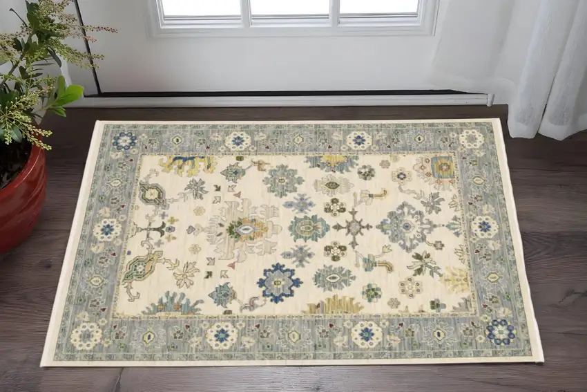Ivory Blue Grey Teal Gold Green And Rust Oriental Power Loom Stain Resistant Area Rug With Fringe Photo 1