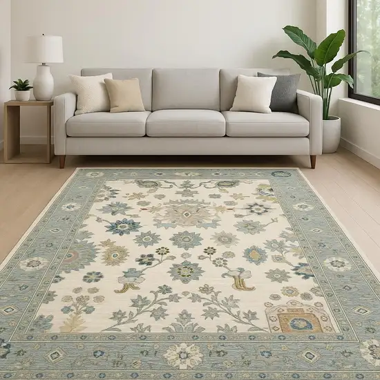 6' X 9' Ivory Blue Grey Teal Gold Green And Rust Oriental Power Loom Stain Resistant Area Rug With Fringe Photo 1