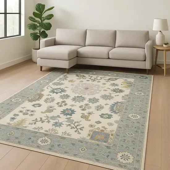 Ivory Blue Grey Teal Gold Green And Rust Oriental Power Loom Stain Resistant Area Rug With Fringe Photo 1